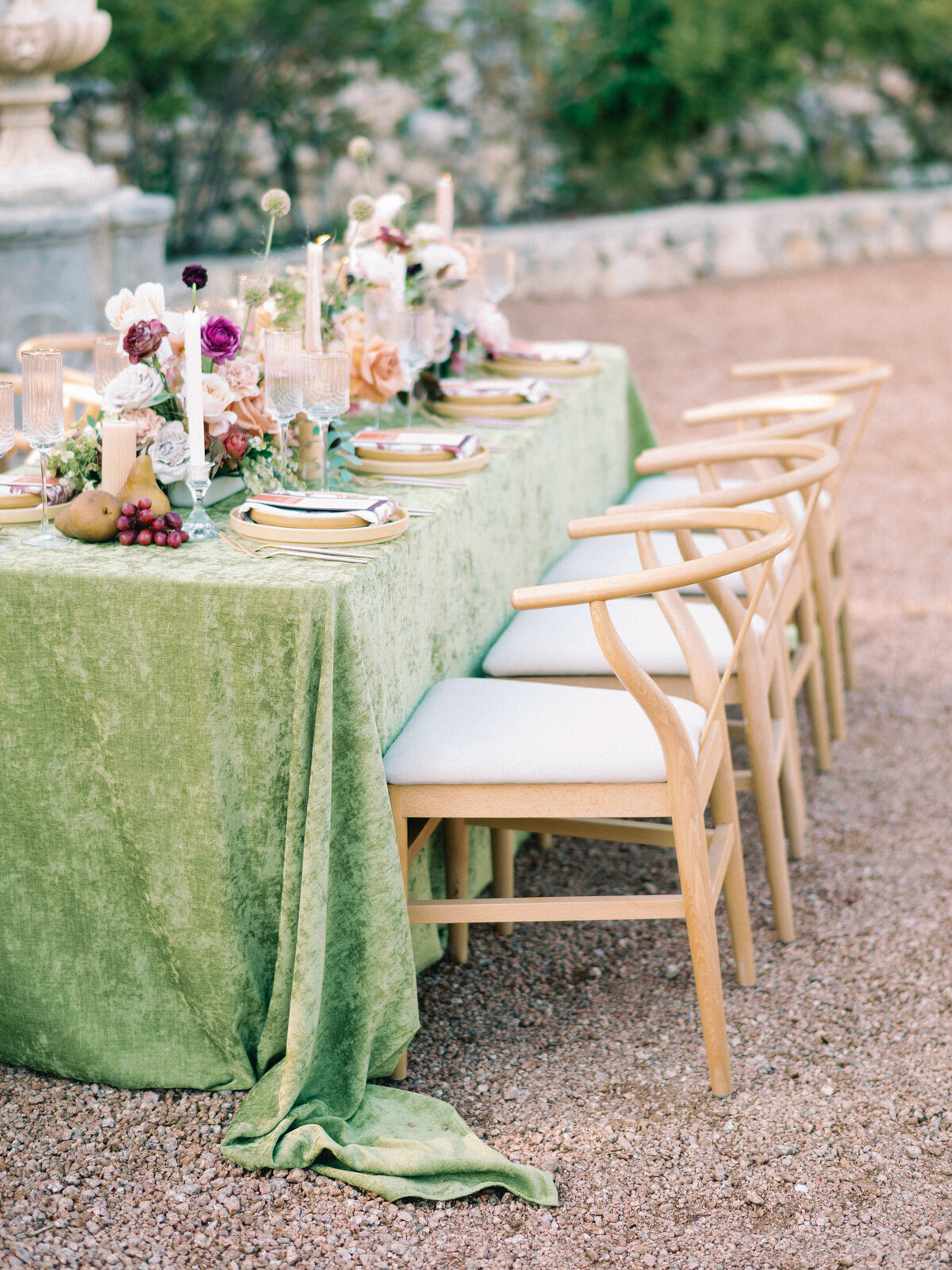 Luxury tablescape with green linens and colorful flowers during reception at Villa Antonia in Austin, Texas