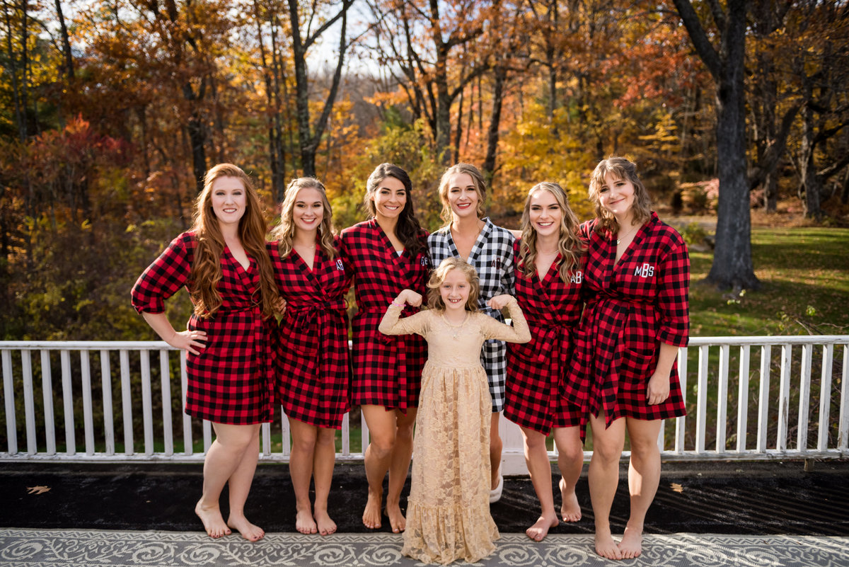 bride with bridesmaids in plaid with autumn leaves