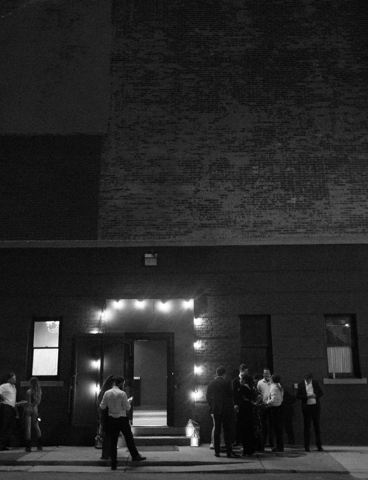 guests gather outside a Detroit warehouse for a wedding afterparty