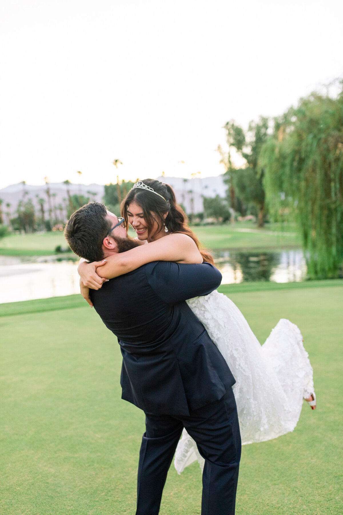 groom lifts nad spins laughing bride