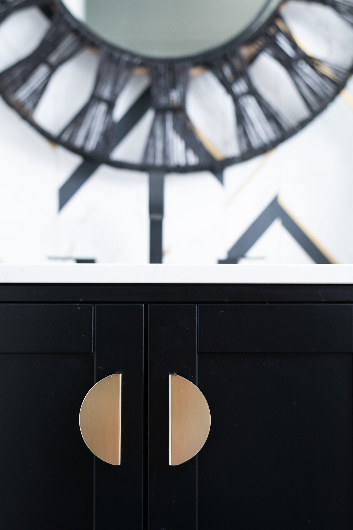 black cabinets with gold semi circle handles
