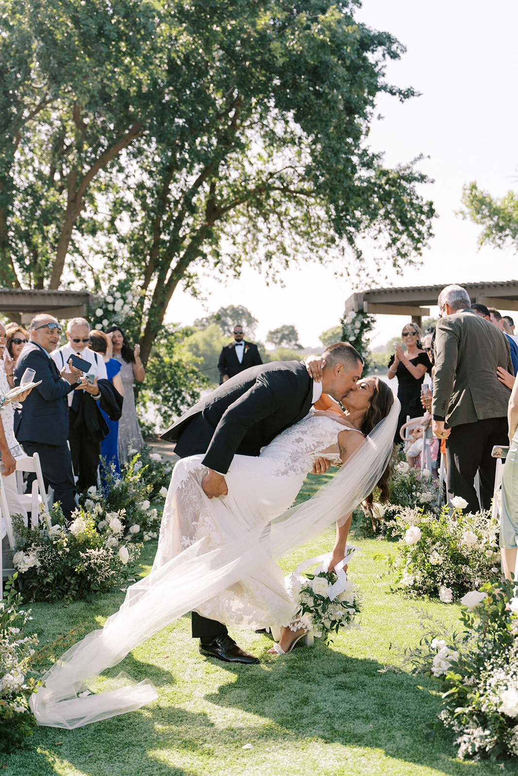 ceremony kiss with flowers down the aisle ceremony wedding