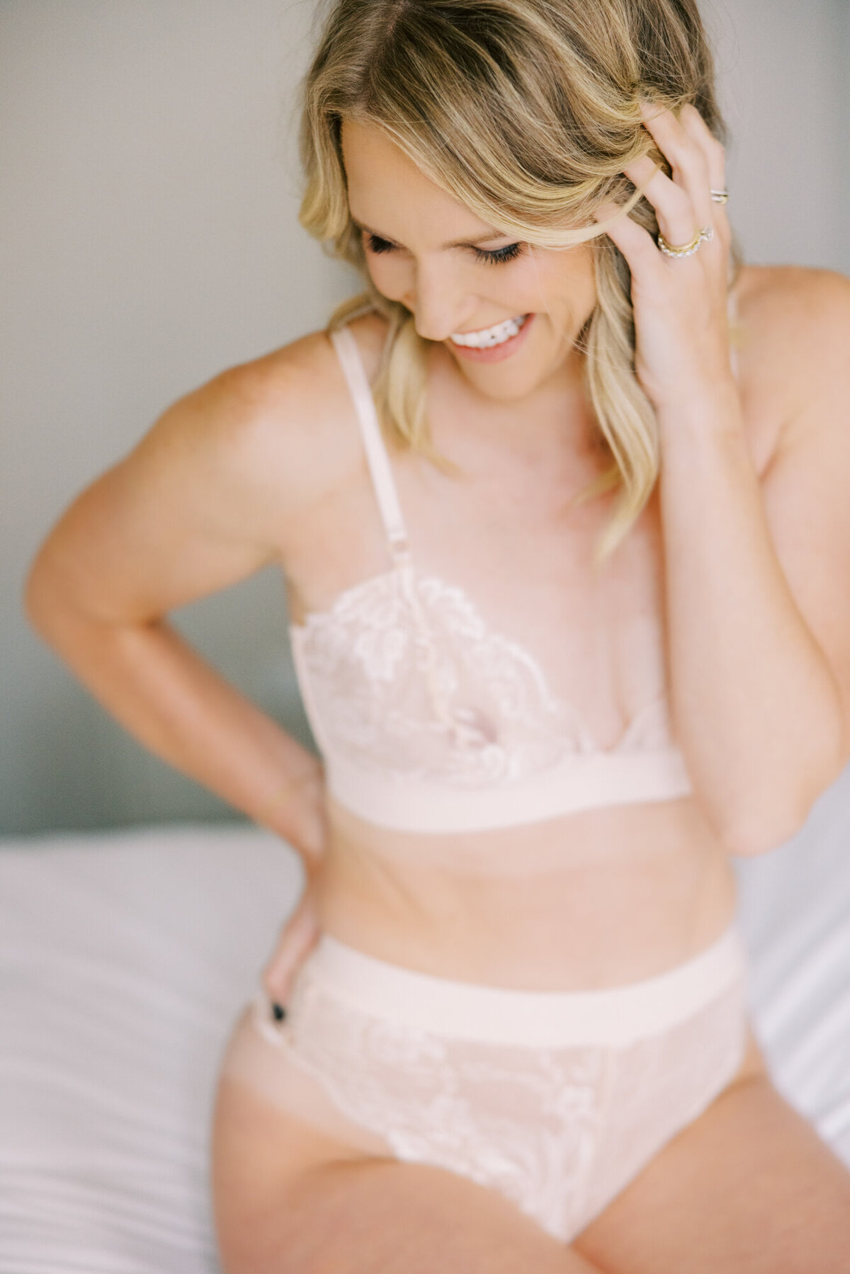 Woman in pastel pink lingerie posing in natural light at the Talbott Hotel in Chicago