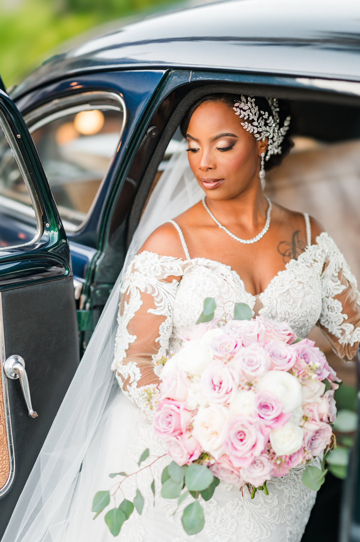 stunning bride posing for her wedding photos in an old car in wilmington, nc
