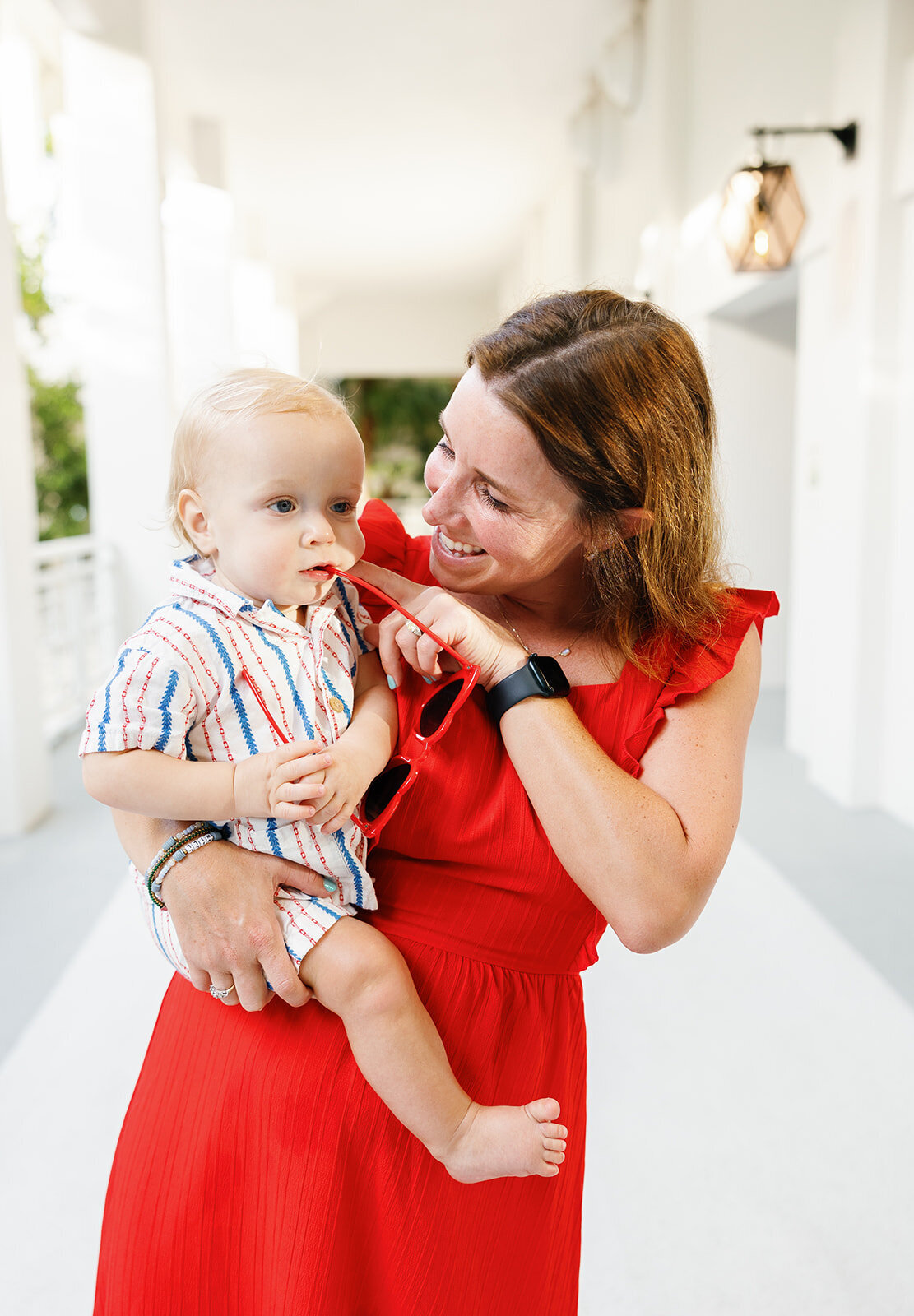 A joyful mother holds her baby close, sharing a playful moment in a Florida Keys family photography session.