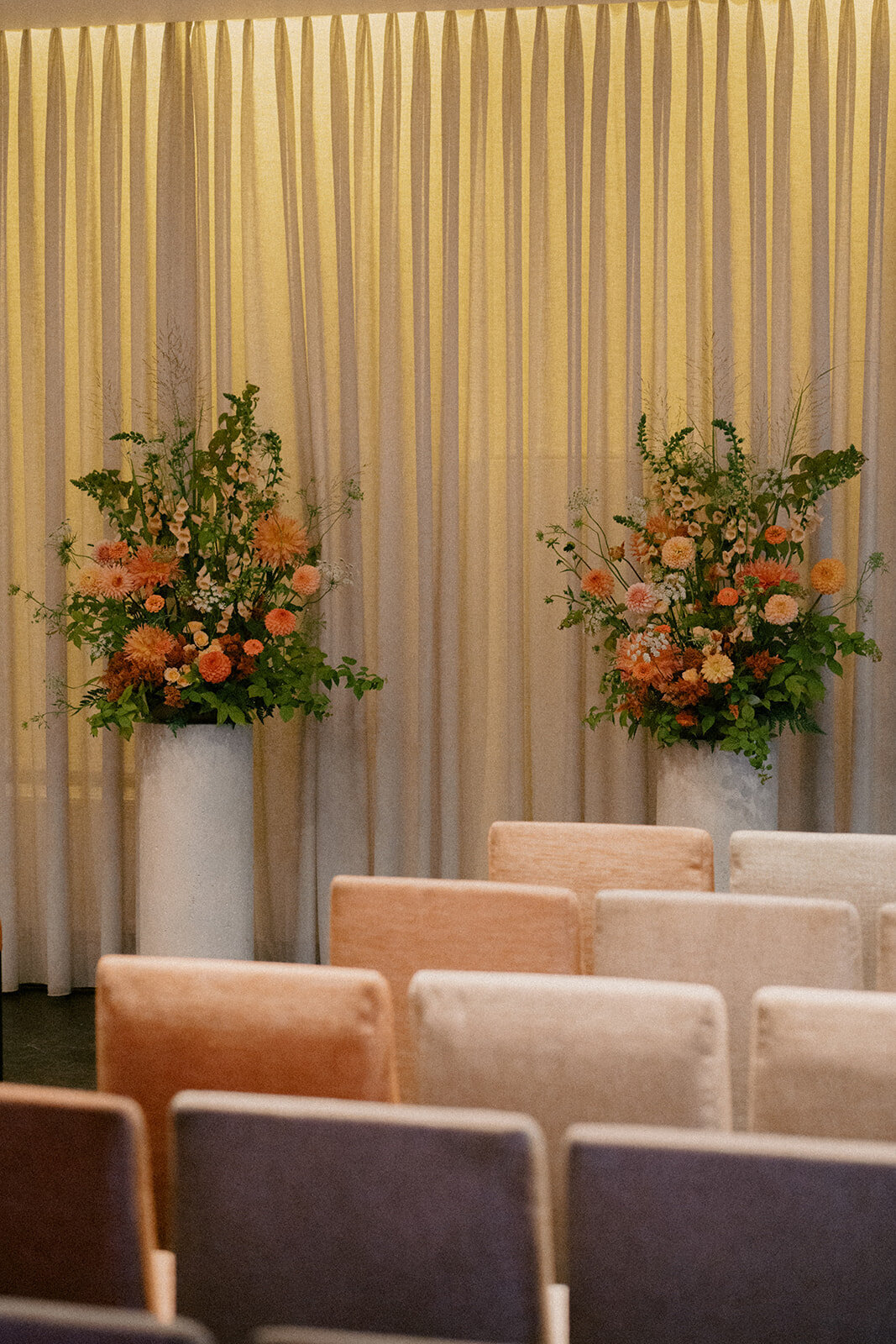 Colourful, lush floral ceremony arrangements for a wedding ceremony at Restaurant Beatrice.