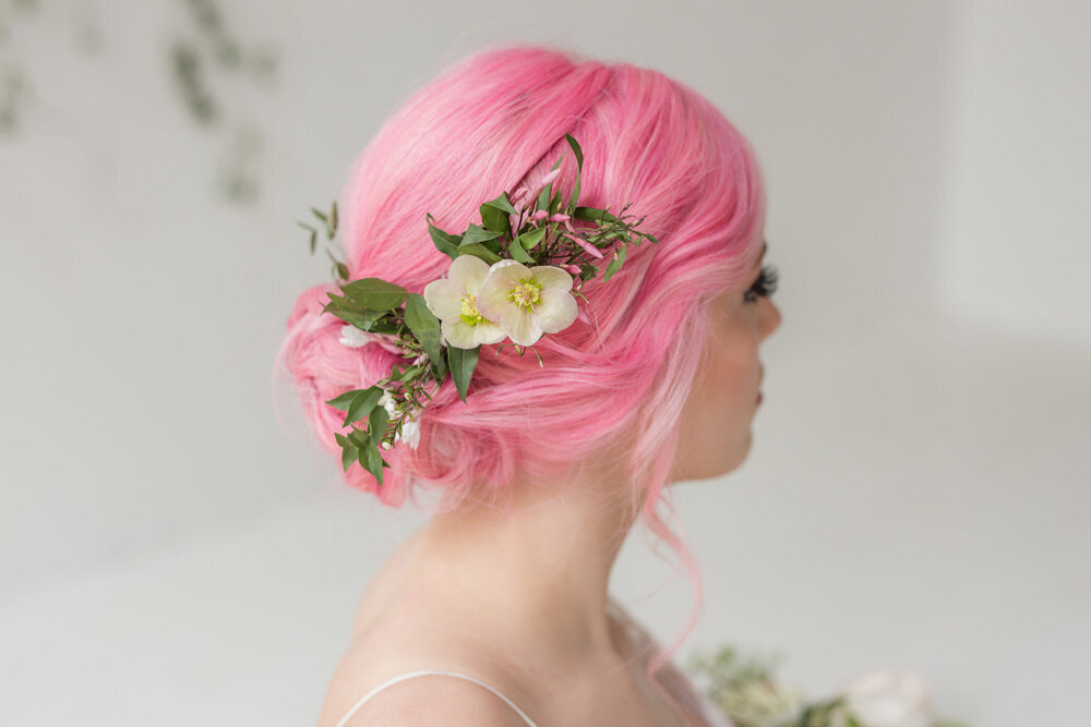  Back of bride’s head showing pretty undo with flowers in pink hair