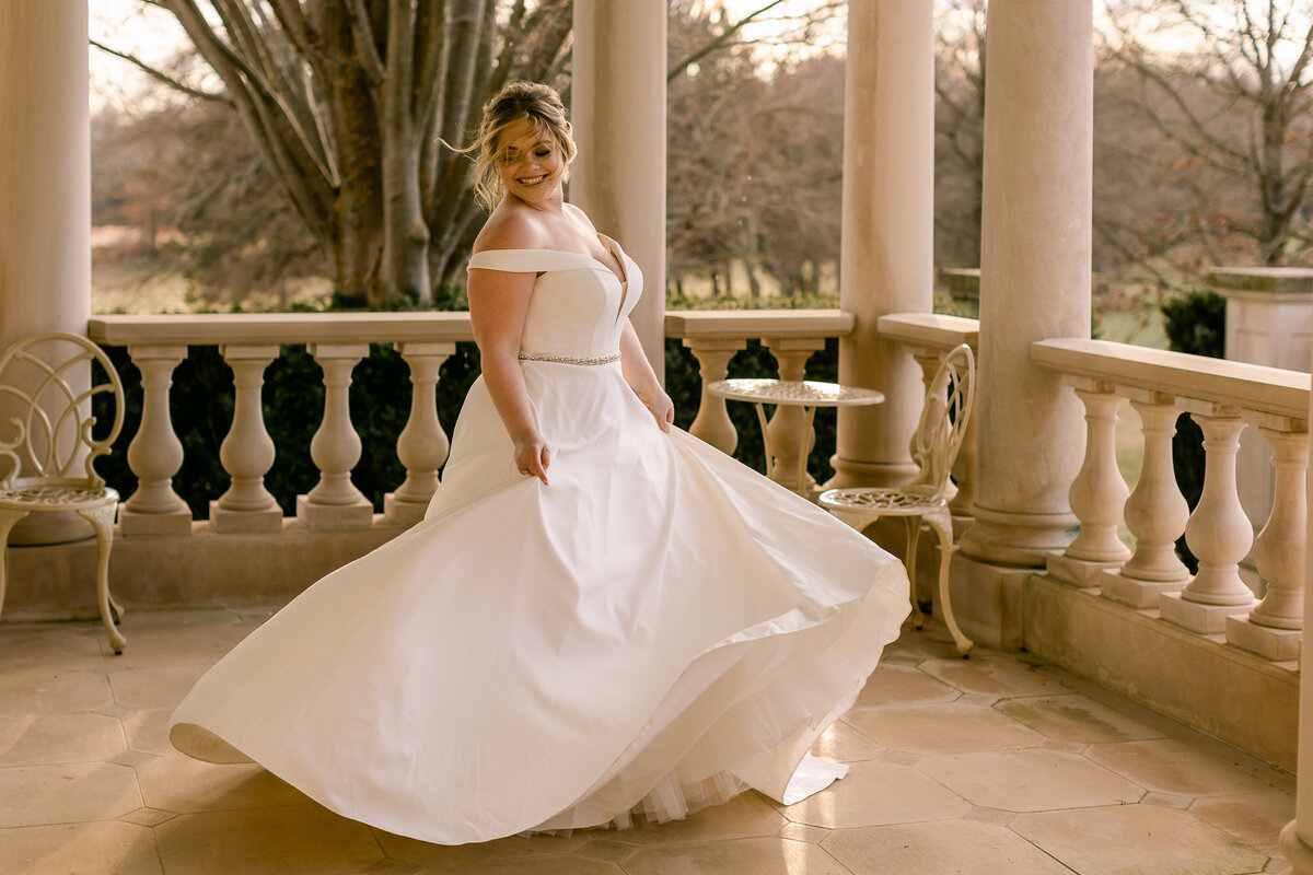 Wedding Photographer, a bride dances in her wedding dress on a large estate porch