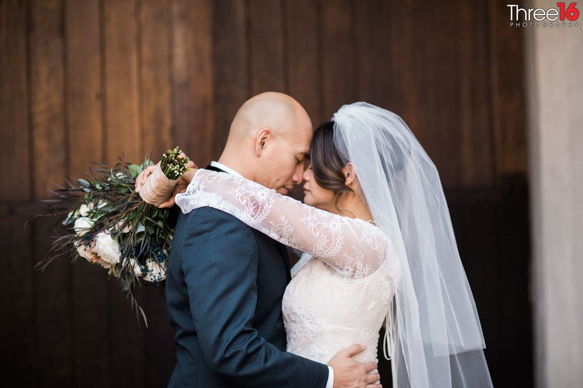 Bride and Groom embrace each other after the ceremony with their foreheads touching each other's