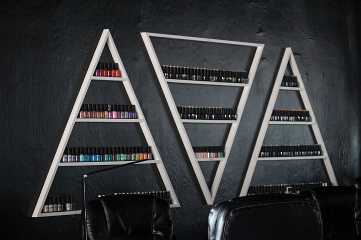Triangle nail racks on the wall at a salon
