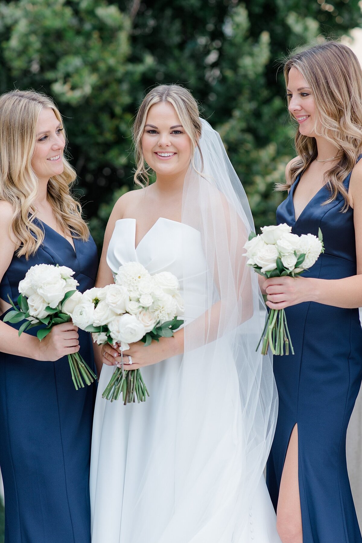 Bride smiling with bridesmaids in classic navy dresses photographed by Ohio Wedding Photographer