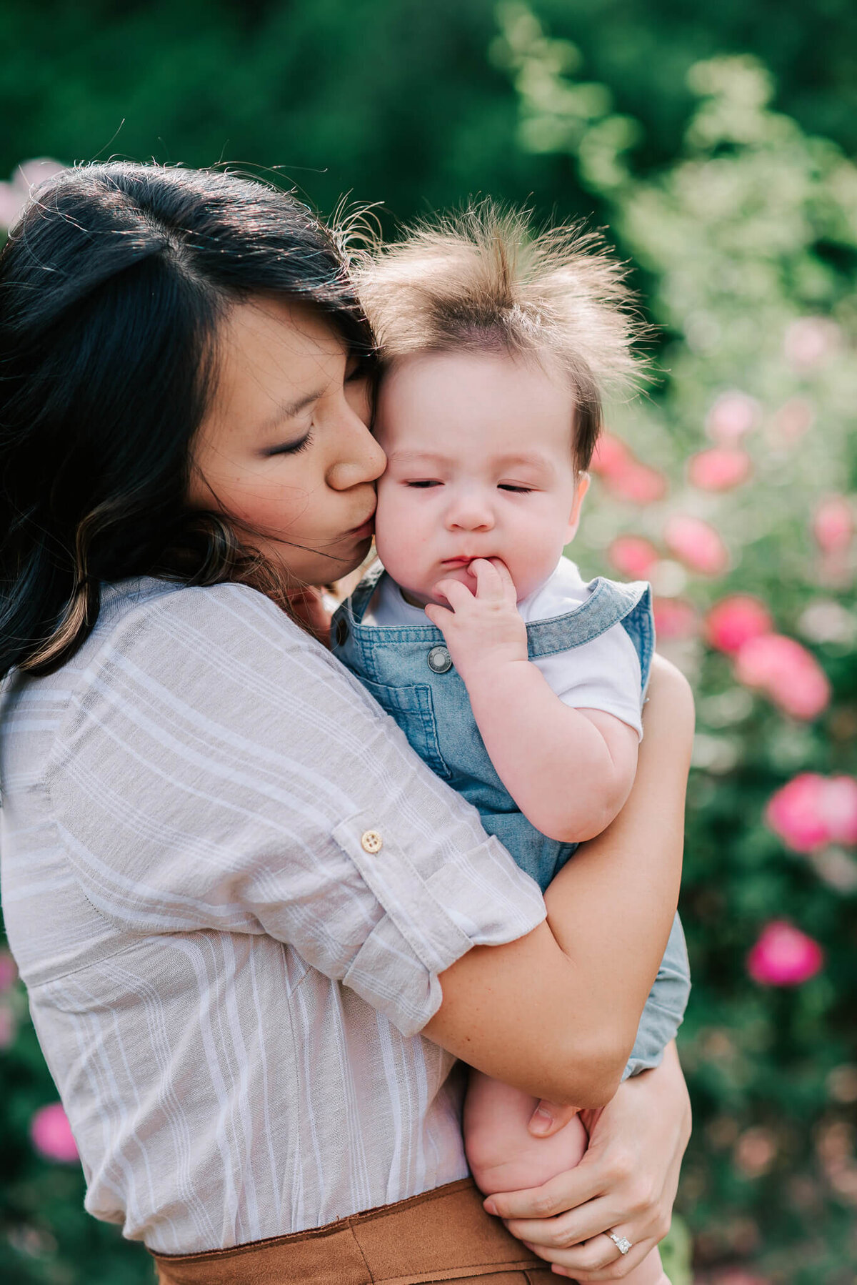 An asian woman kissing her biracial son in Arlington VA