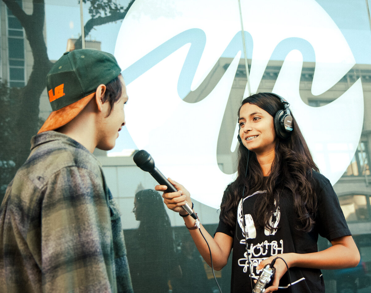 Teenagers working together in front of the YR Media logo