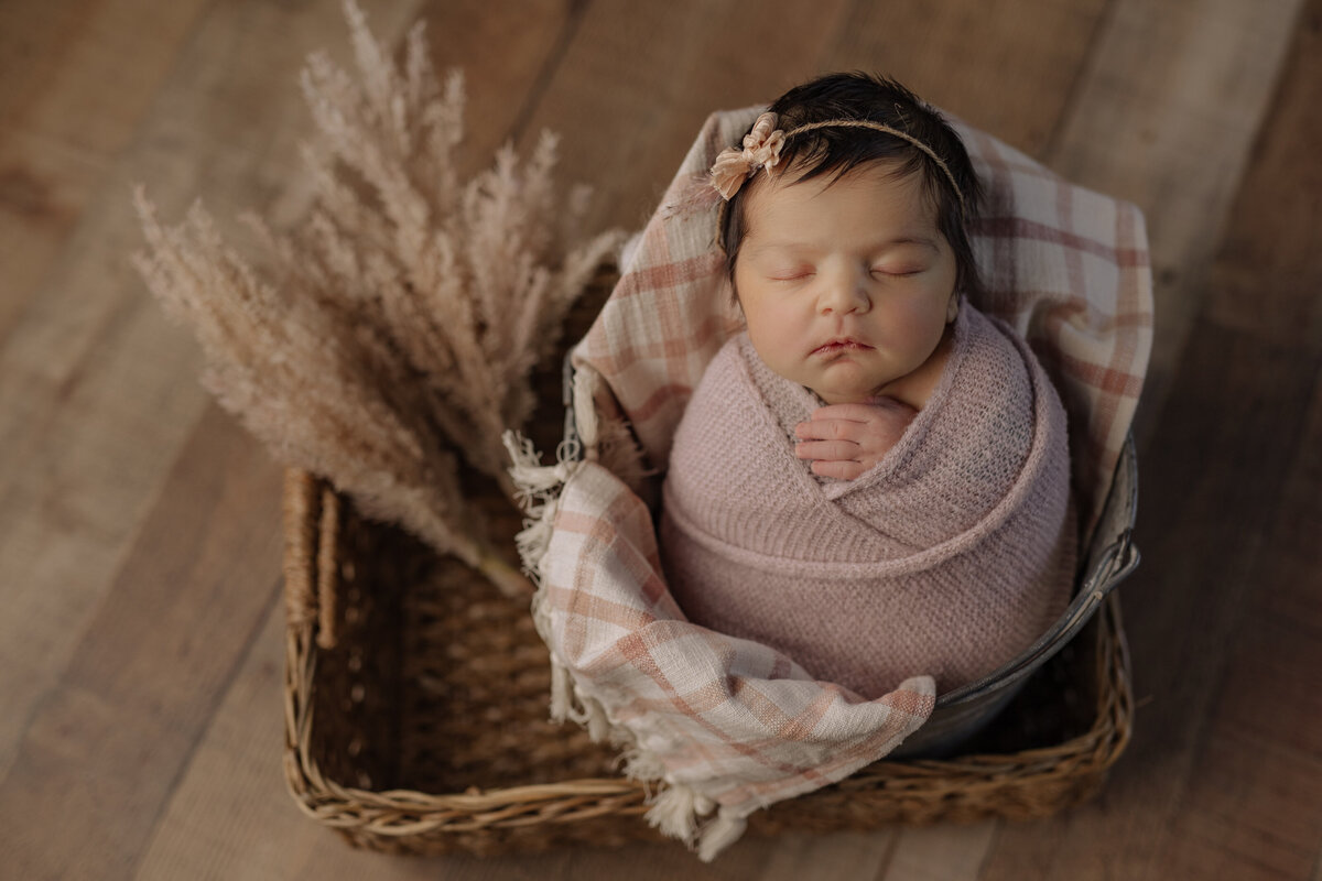 Newborn girl wrapped in pink at Kelly Adrienne Photography