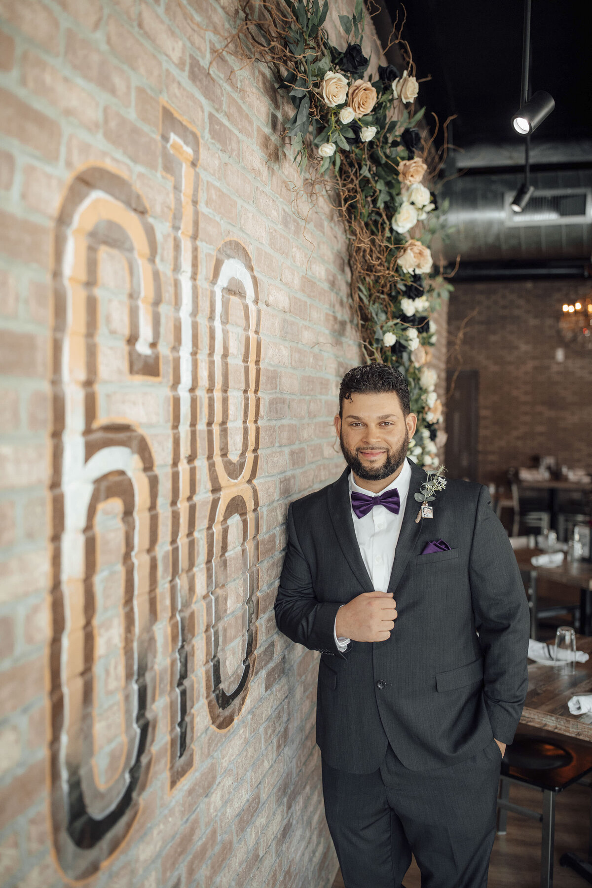 618-restaurant-summer-wedding-photo-groom-posing-stone-wall-freehold-new-jersey