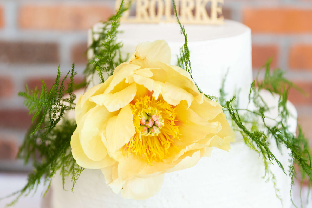 Wedding cake with yellow flower at Fat Bottom Brewery wedding in Nashville, TN
