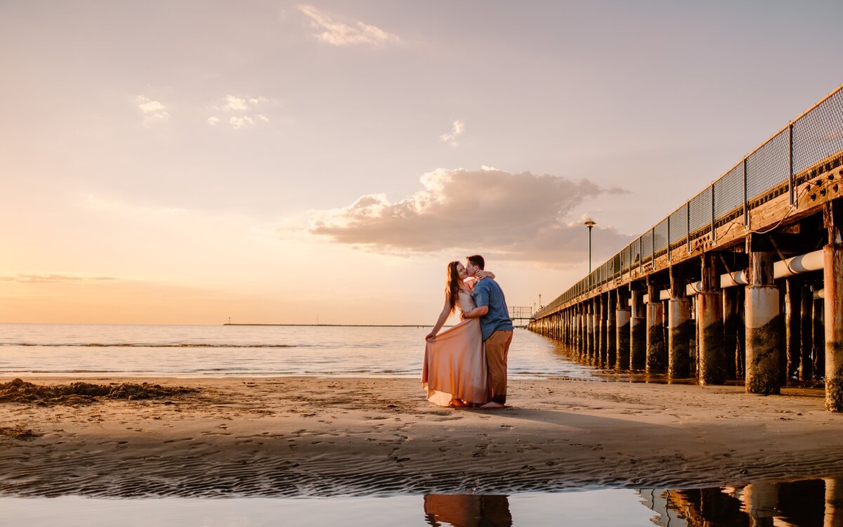 Engaged couple on the beach at sunset