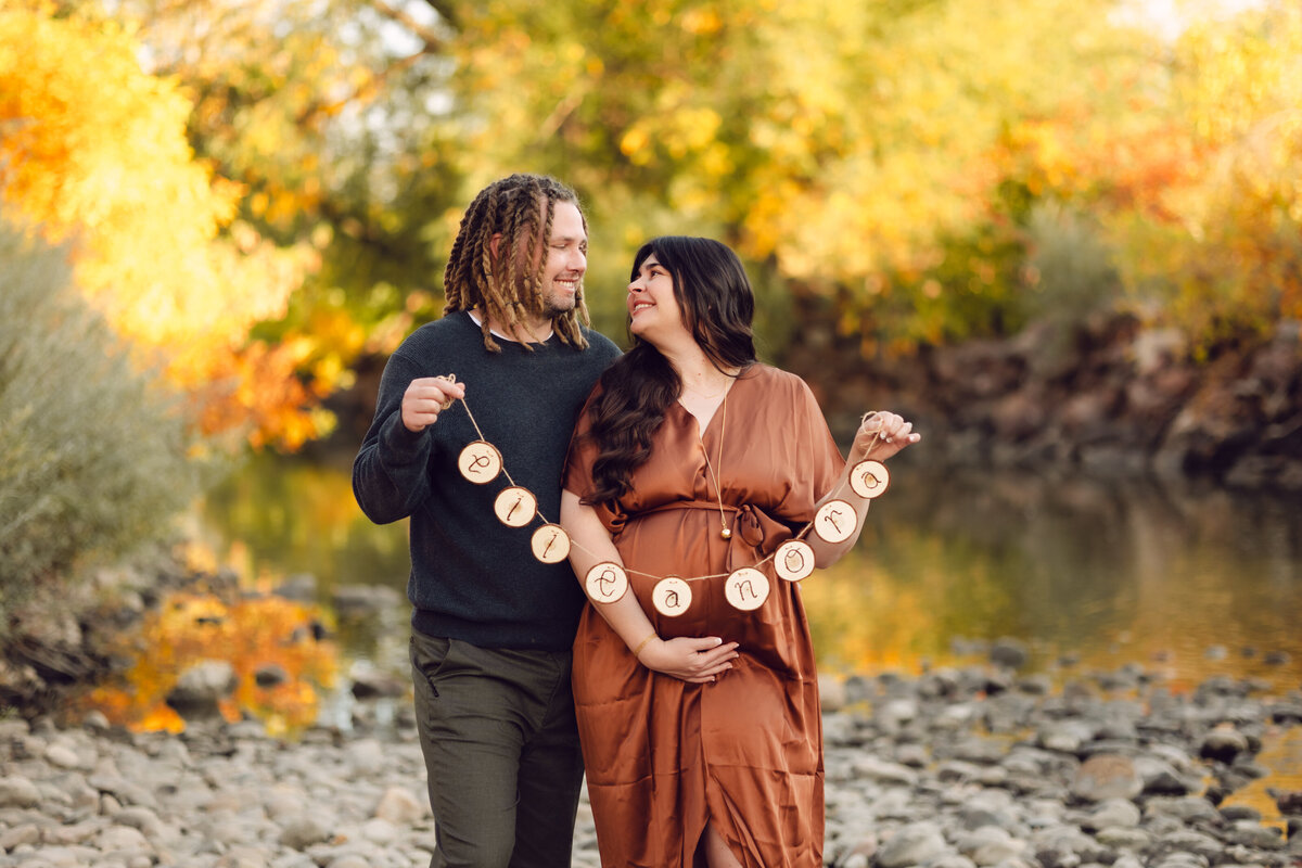 A couple poses for a photo during their fall maternity session in Fort Collins, Colorado
