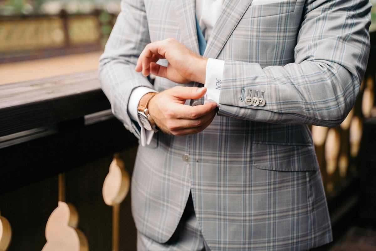 Close-up of groom’s tuxedo and custom embroidery at luxury Tuscan wedding.