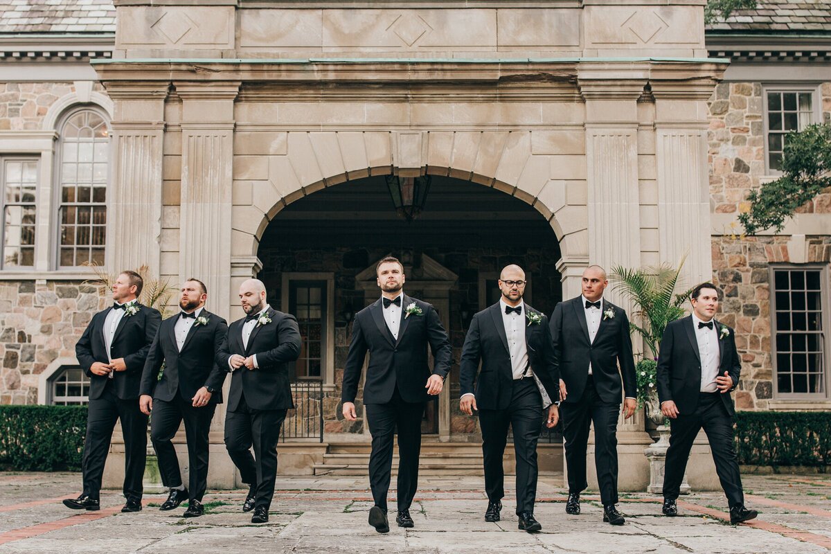 Portrait of groomsmen walking photographed by Nova Markina