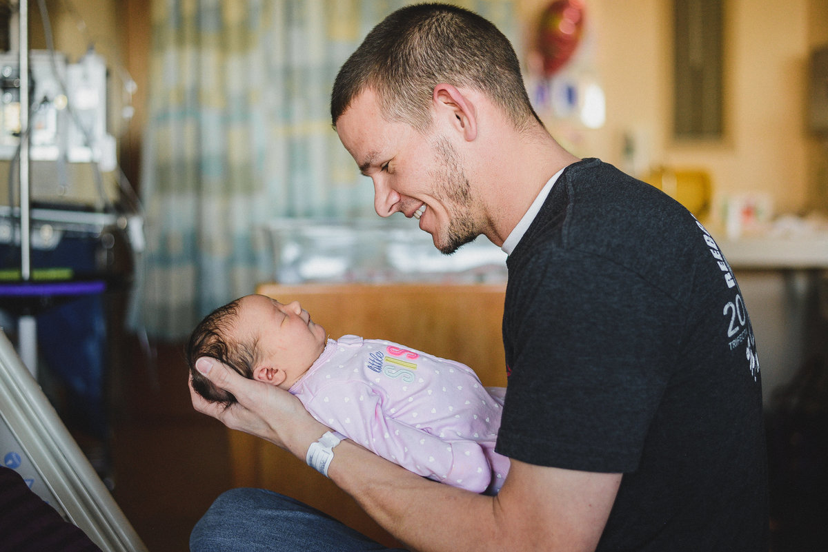 holding a newborn baby