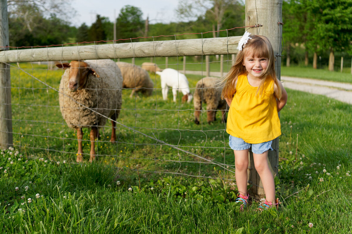girl with sheep outdoor daytime portrait