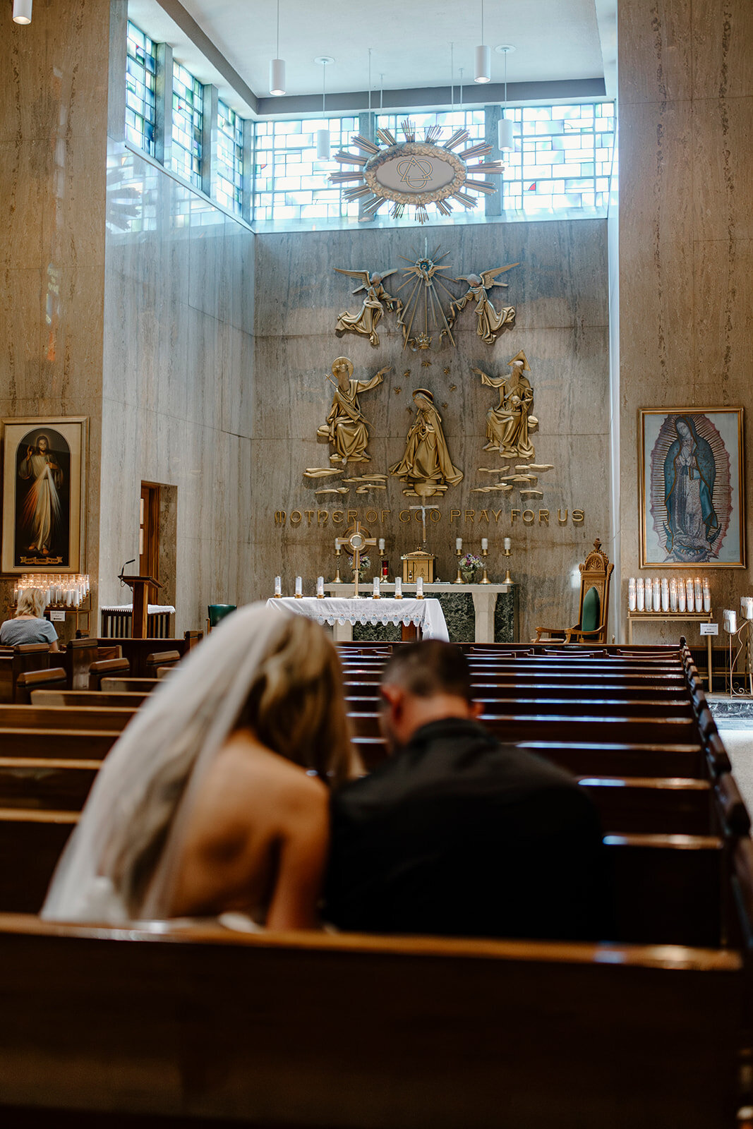 bride and groom pray in south dakota adoration chapel