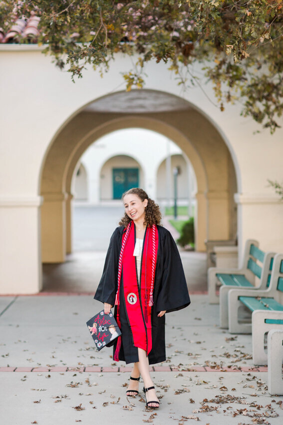 San Diego State senior walking under tree