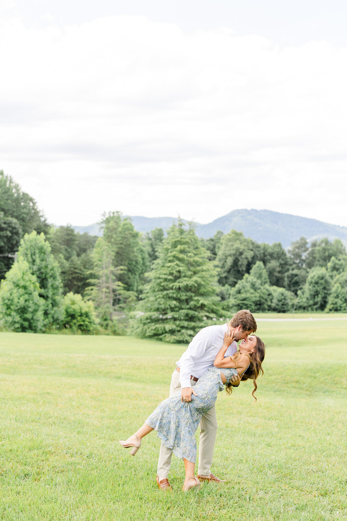 couple dipping with mountains behind them at hotel domestique