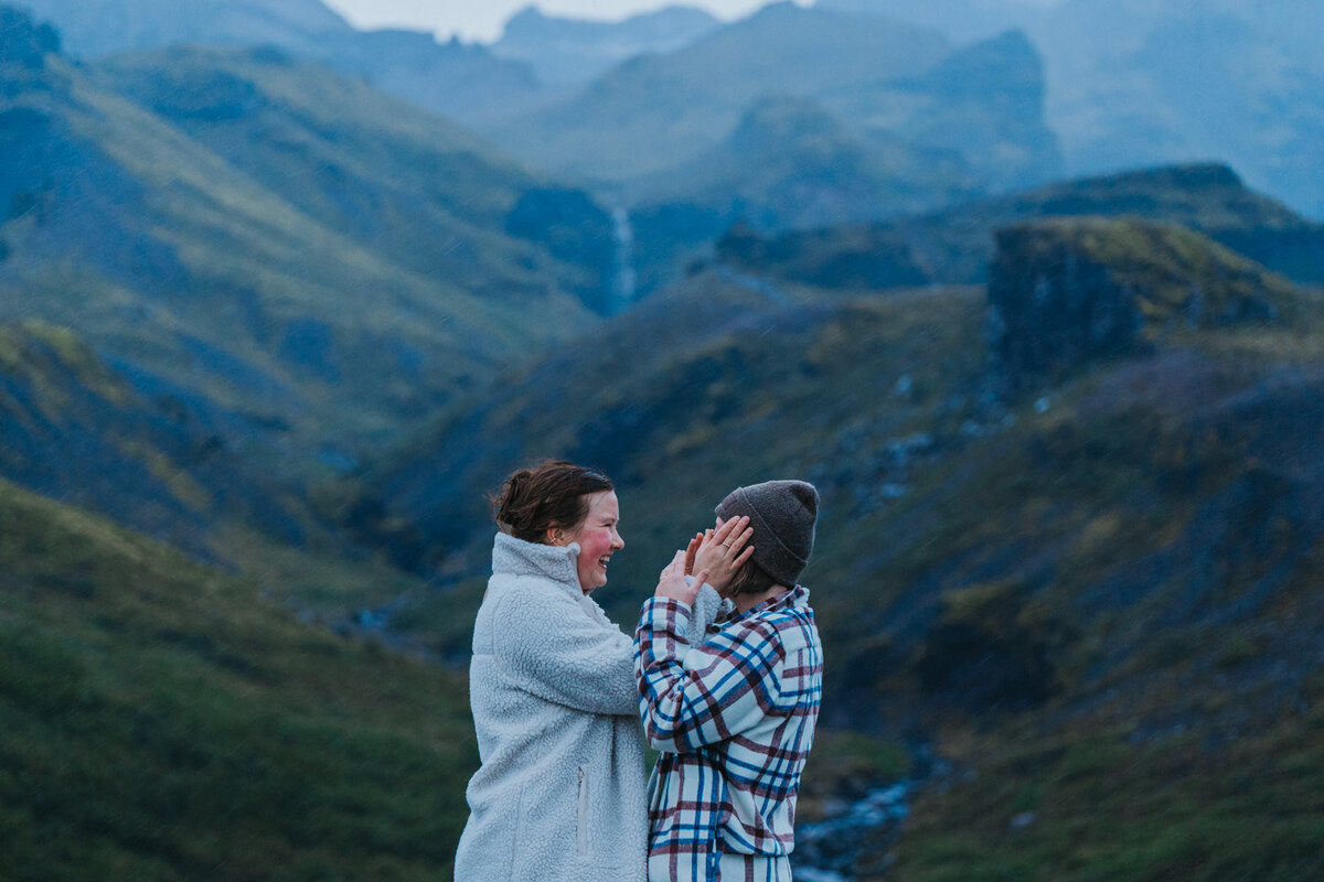 Women smile and laugh after saying "I do" during their Iceland elopement 