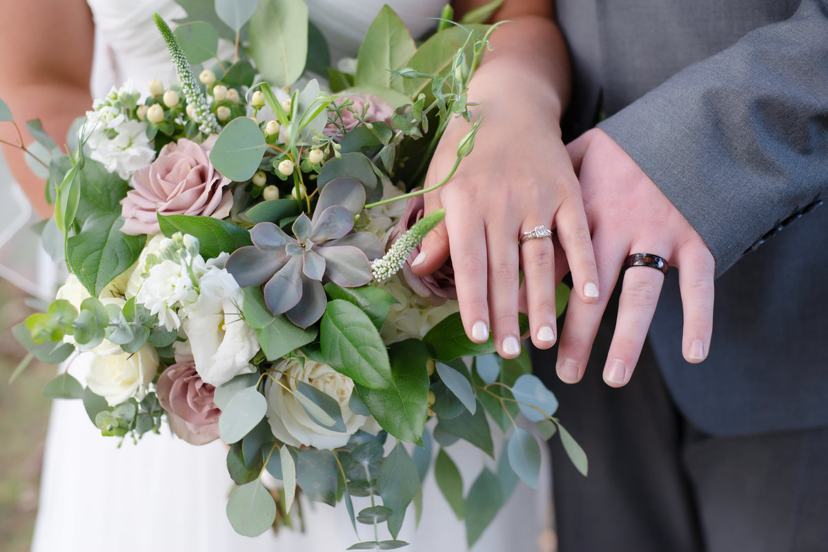 Bride and grooms hands and rings at york maine wedding