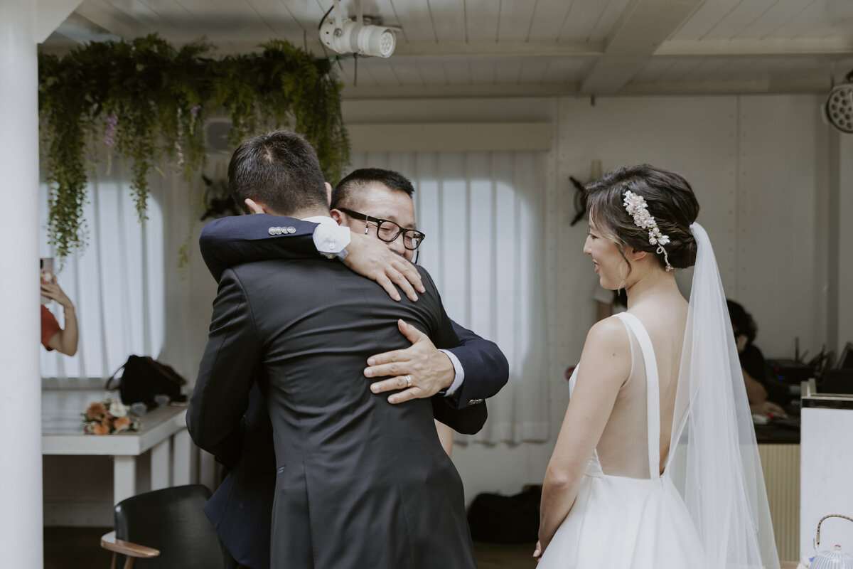 the groom hugging the bride's father