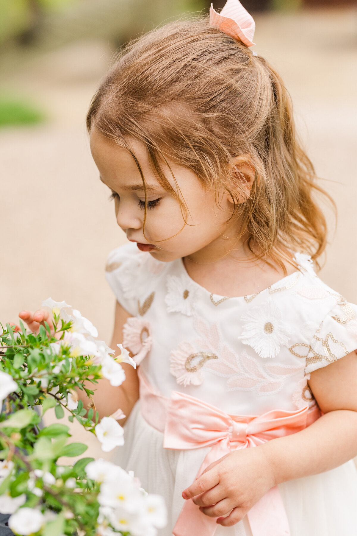 two-year-old-smelling-flowers