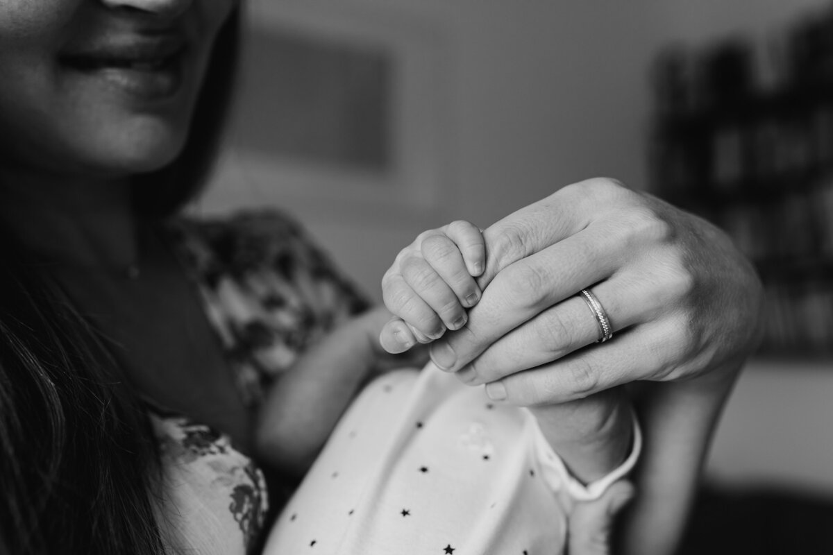 Newborn Photographer, a mother holds her little baby's plan