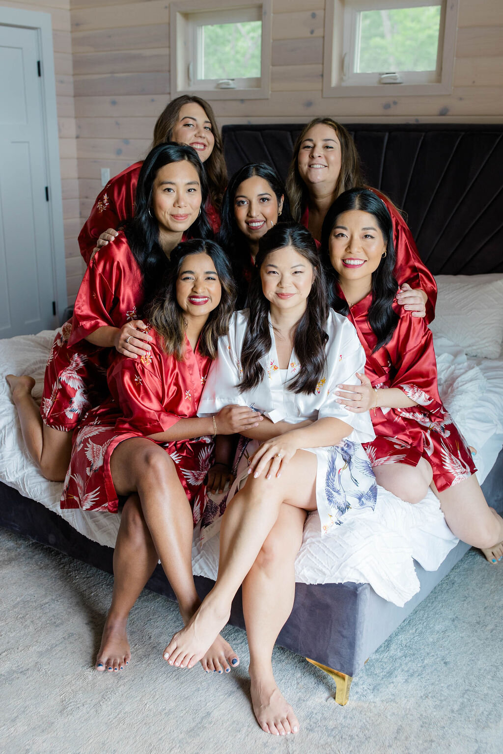 Maine bridal party smiling in red robes
