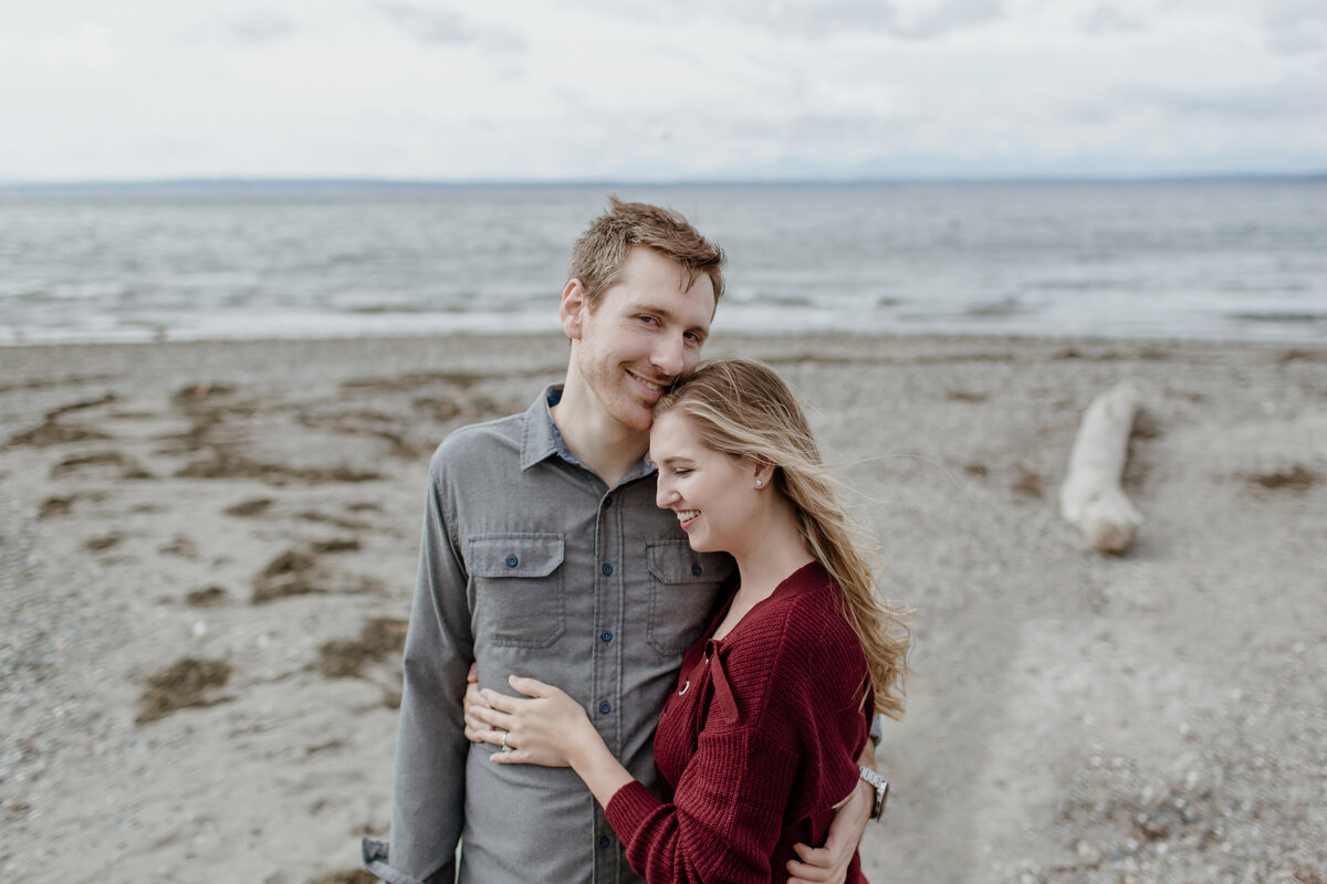 A sweet and cozy engagement session at a Seattle beach. Captured by Fort Worth wedding photographer, Megan Christine Studio