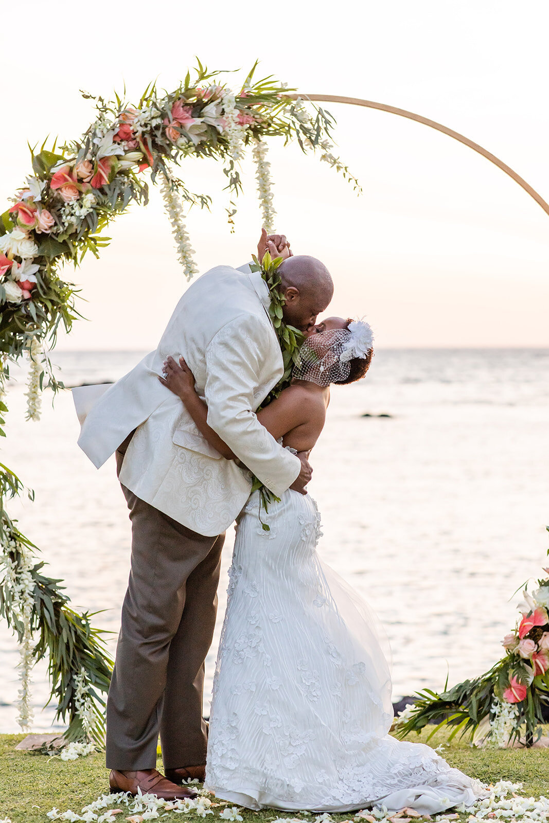 Kona Wedding PlannerBride and groom sharing a romantic snuggle at sunset at Holualoa Inn on the Big Island of Hawaii, Kailua Kona, a scenic wedding photo moment.