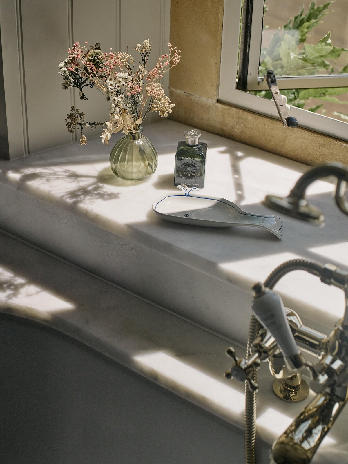 Bathroom accessories on marble worktop in the sunlight