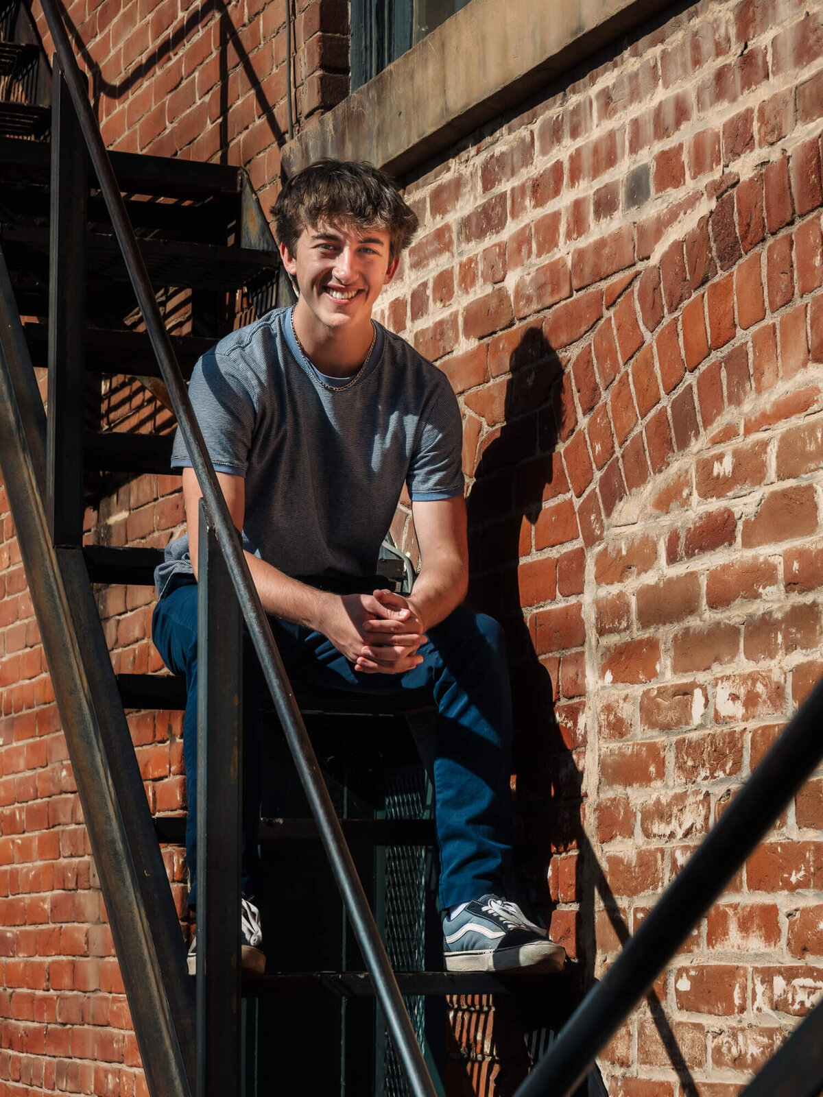 Boy poses on steps in Prescott senior photography session