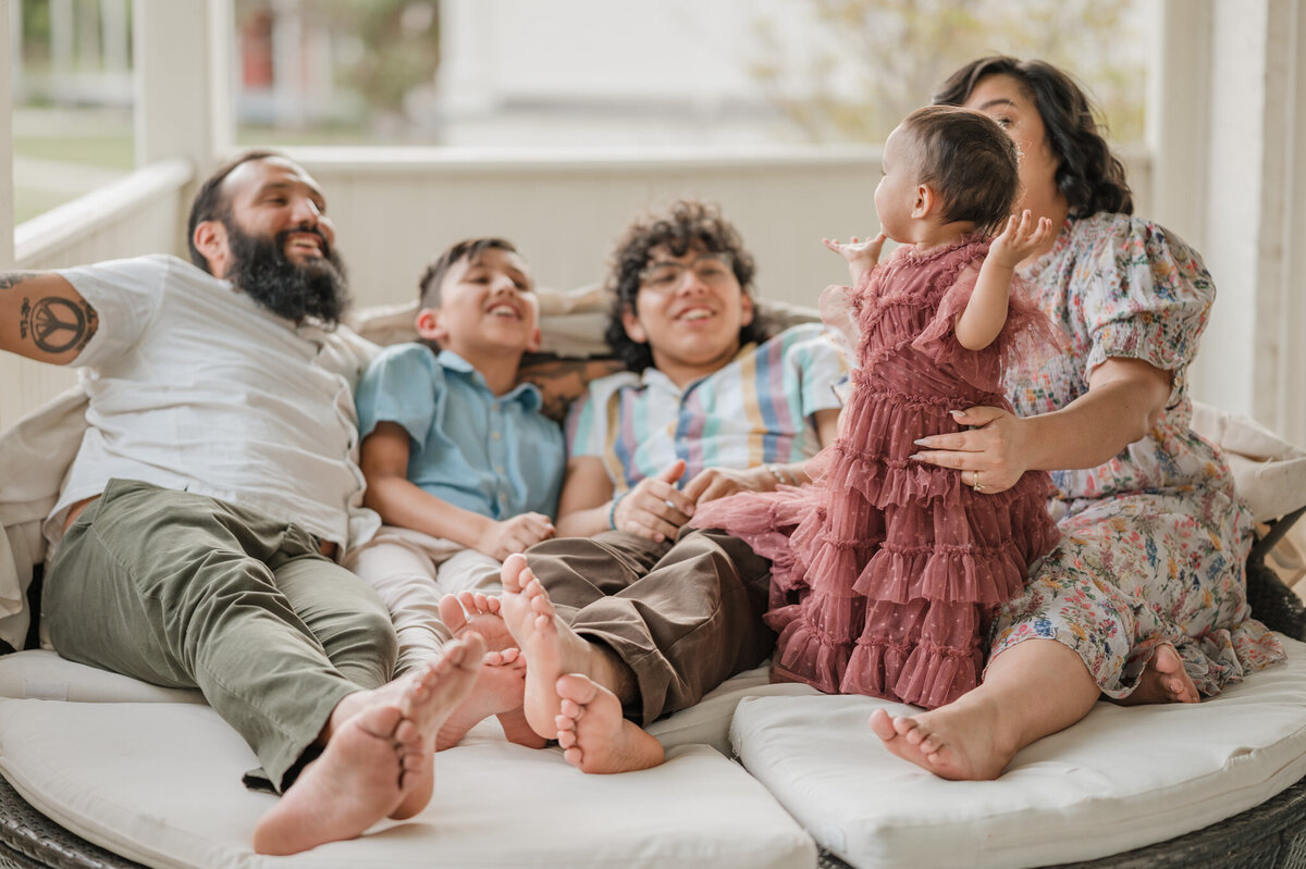 A family sings songs along with a little girl during a family photography session in San Antonio.