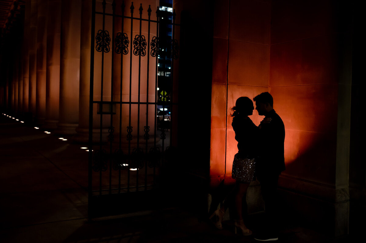 A couple is silhouetted in red at the Chicago Union Station