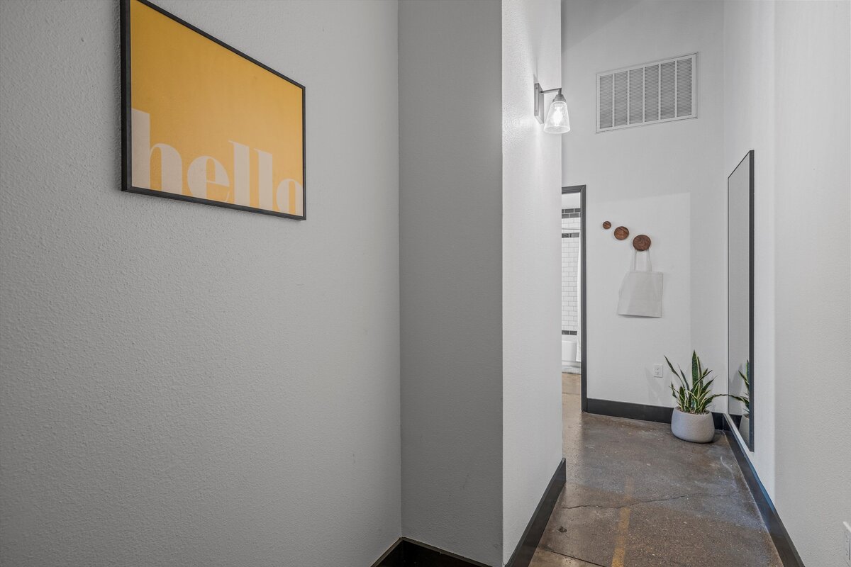 Entry hallway in this one-bedroom, one-bathroom loft vacation rental condo with high speed WiFi, fully stocked kitchen, and room for four guests in downtown Waco, TX.