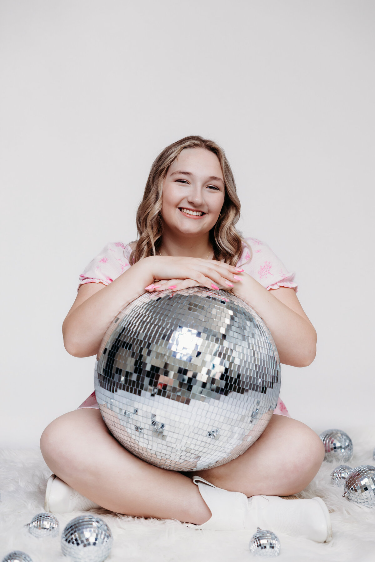 senior-girl-holding-disco-ball