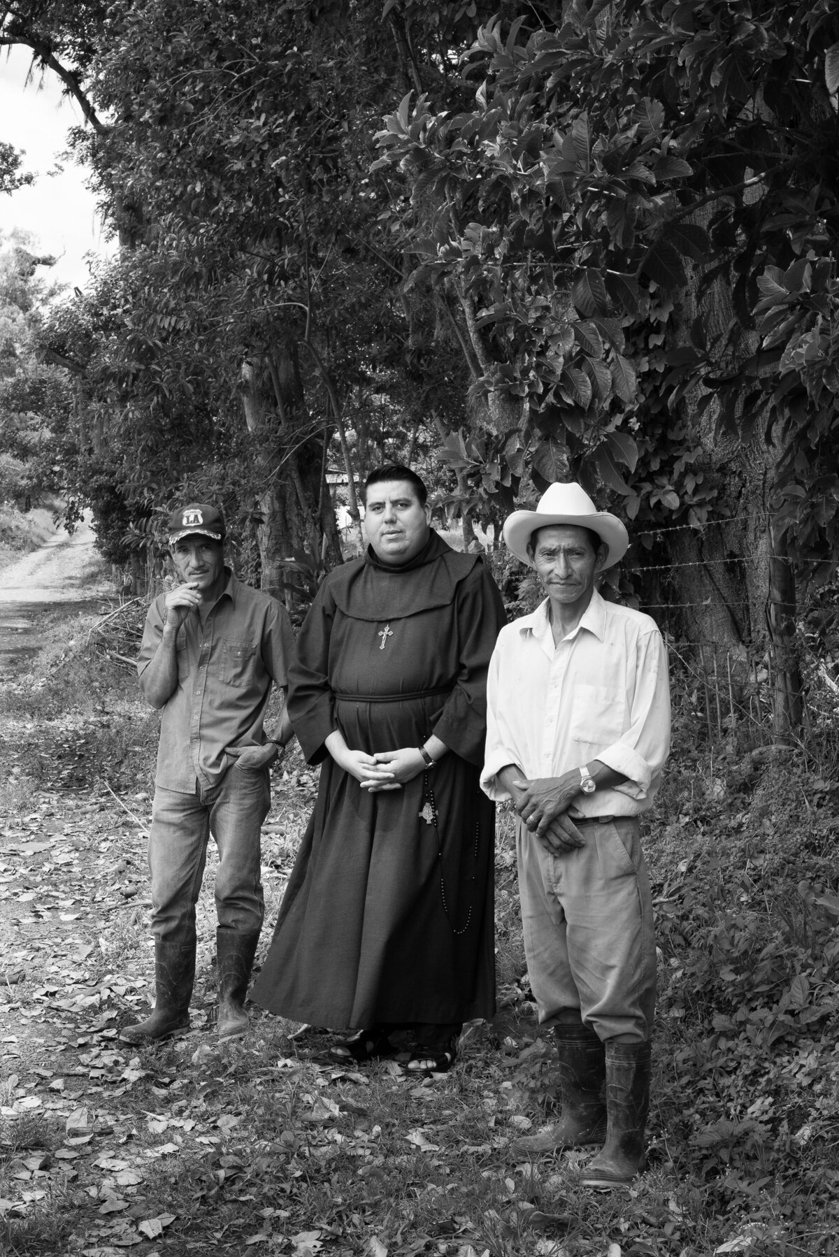 three men stand seriously on side of road nicaragua