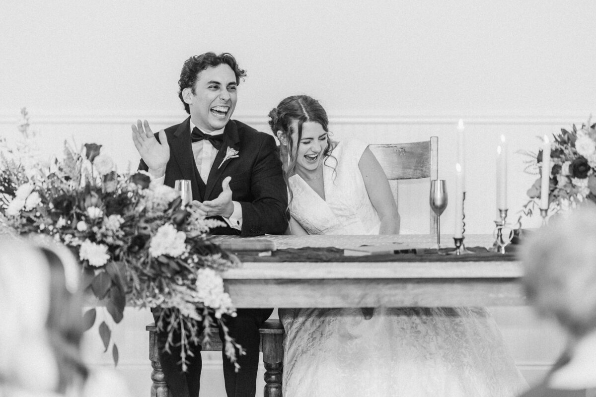 bride-and-groom-laugh-with-toasts