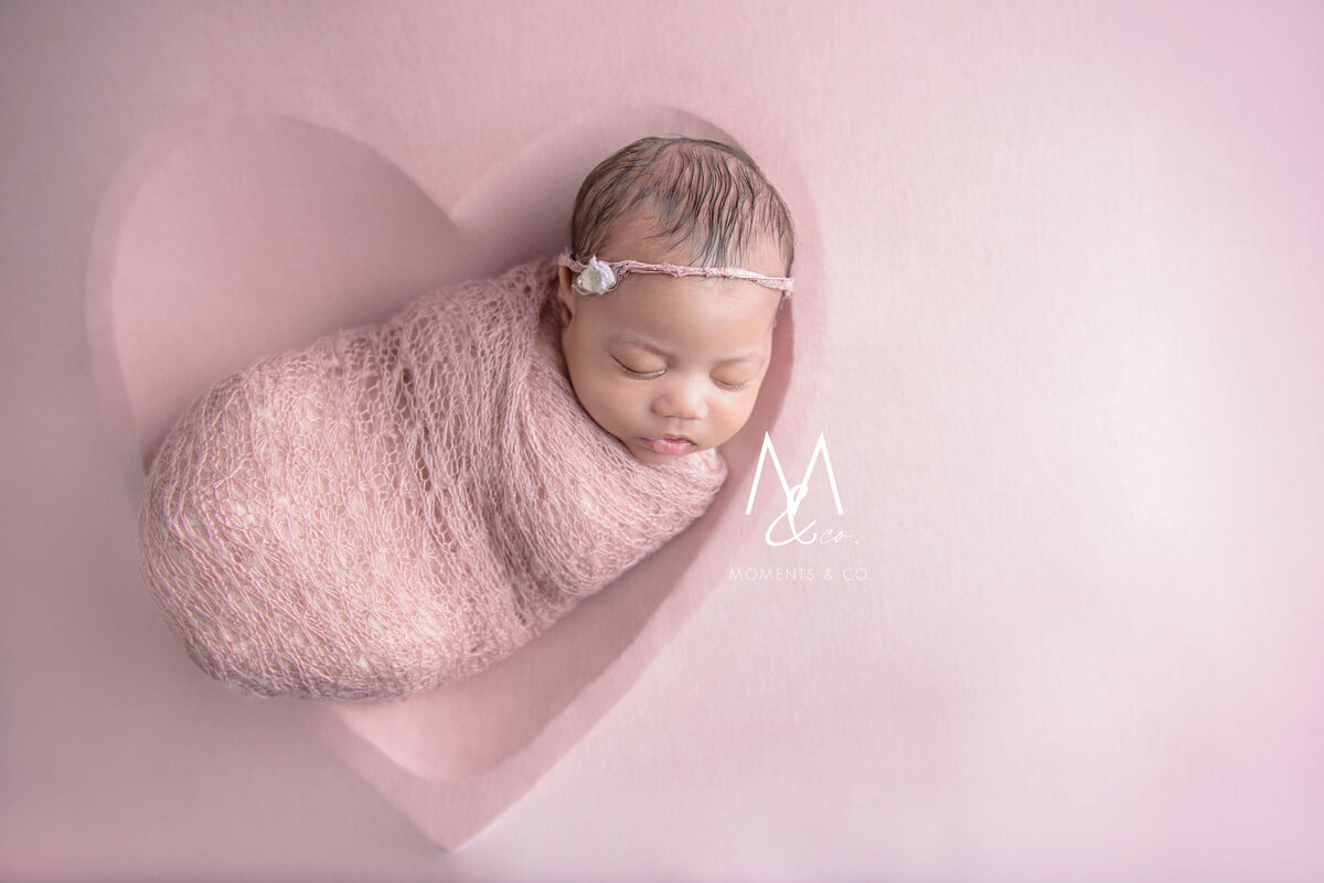 Heart-bowl-under-pink-blanket-with-newborn-sleeping-wrapped-in-pink-image