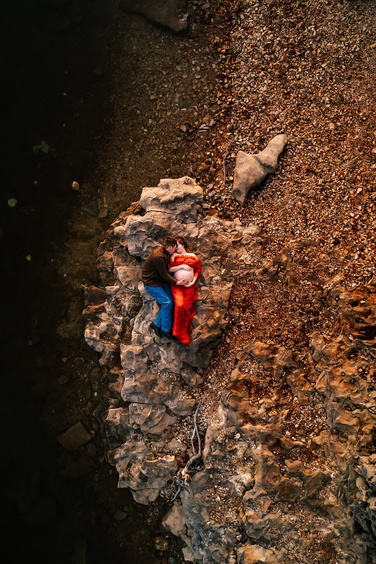 drone photo of Jessica Kennedy of The XO Photography on rock near lake in Springfield MO