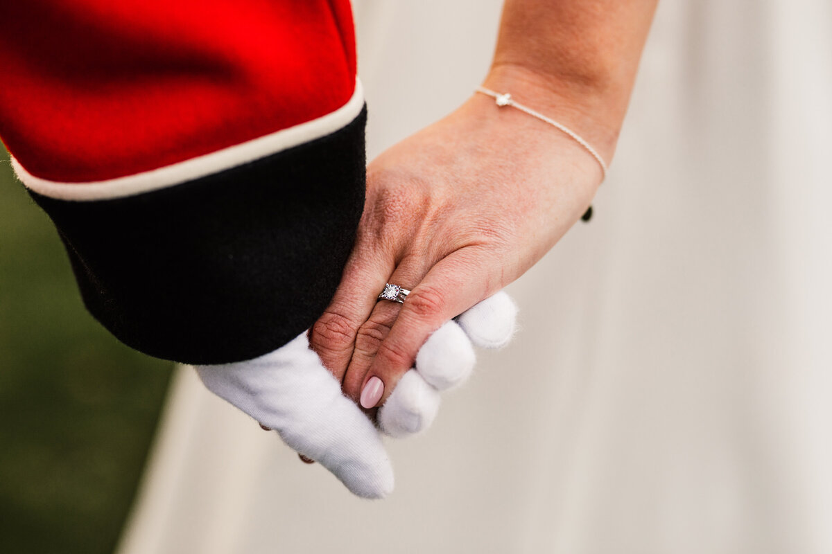 Detail shot of bride and groom holding hands