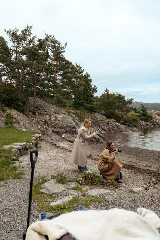 Female fashion photographer and content creator are working on a photoshoot in Norway