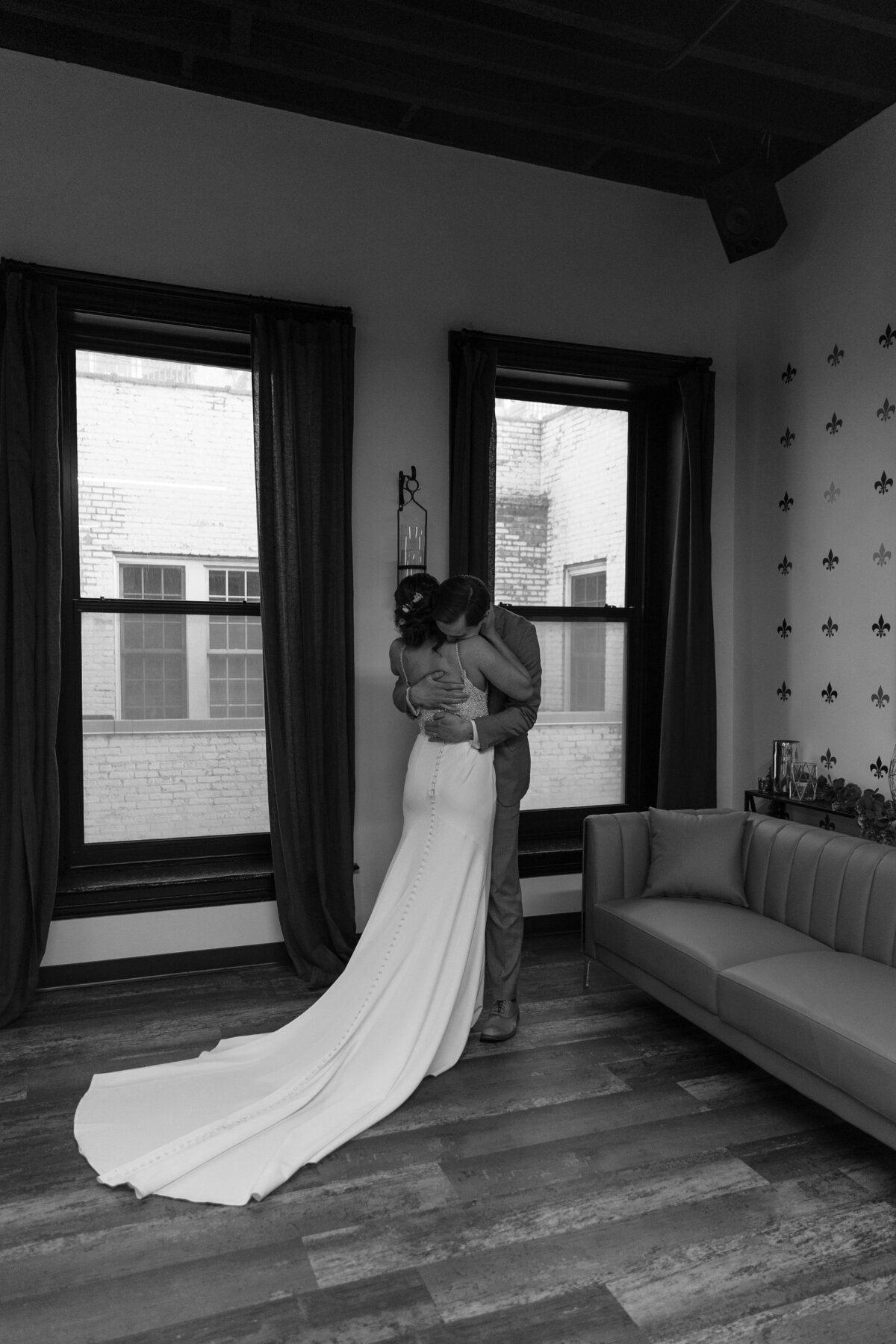Indoor black and white wedidng couple first looks 